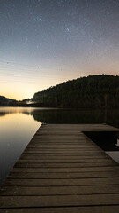 Canvas Print - Scenic view of a pier on the peaceful lake at sunrise