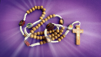 Wall Mural - Holy Rosary on purple background. Christian prayer concept