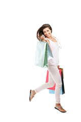 Wall Mural - Payday is splurge day. Studio portrait of a happy young woman carrying shopping bags against a white background.