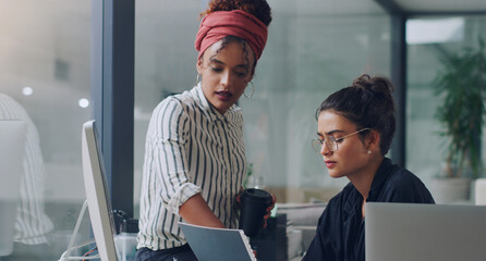 Poster - Can I take a look. Cropped shot of two attractive young businesswomen working together in the office.