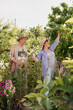 © diignat - Lovely senior couple relaxing in the garden among trees and flowers. Happy life and healthy relationship. Beautiful family