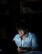 © insta_photos - Young indian ethnic businessman developer or web designer wearing glasses typing on laptop distance working online late at night at home or in dark office using laptop sitting at workplace desk.