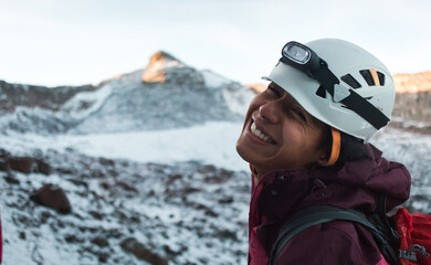 Poster - Closeup portrait of dark beautiful young woman in mountaineering gear hiking 