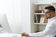 © SHOTPRIME STUDIO - handsome businessman in a white shirt sits at a computer work documentation executive