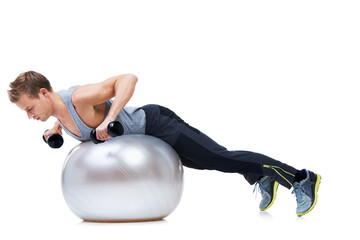 Wall Mural - Really working those arms. Shot of a man balancing on an exercise ball lifting weights.