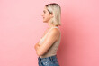 © luismolinero - Young caucasian woman isolated on pink background in lateral position
