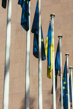 The Flag Of The European Union And Ukraine Flutter In The Wind