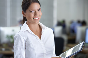 Poster - She leads the best team in the business. A gorgeous young business woman using her digital tablet in the office.