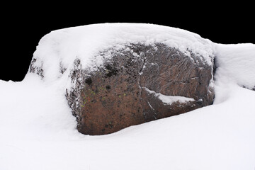 Poster - natural stone in snow isolated on black background