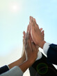 © Diane M/peopleimages.com - Go team. Cropped shot of a group of businesspeople giving each other a high five outdoors.