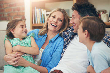 Poster - Time is the most valuable thing to spend on family. Shot of a happy family relaxing on the sofa together at home.