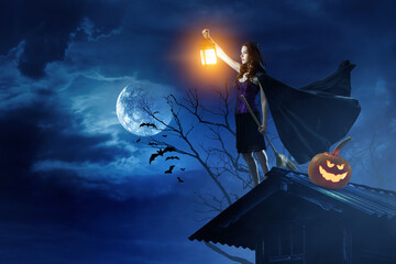 Wall Mural - beautiful young woman in witches hat and costume