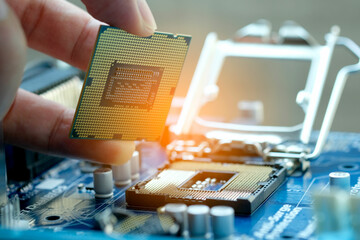 Hand of computer engineering brings computer cpu processor memory change components into socket processor for maintenance.Technology and development concept