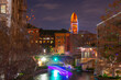 San Antonio River Walk at St Mary's Street with Bexar County Courthouse at the background at night in downtown San Antonio, Texas, USA.