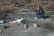 a female forensic expert photographs the body of a dead homeless girl who died in a car accident on