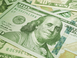 Wall Mural - american paper money. a $100 bill with focus on eyes of benjamin franklin. us banknotes close-up. bu