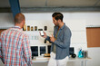 © D Laflor/peopleimages.com - Sharing his thoughts on a developing app. Shot of a young man showing his coworker something on a mobile phone.