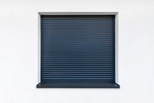 Large Window In Anthracite Color With Fully Covered External Blinds, View From The Outside Of The Building.