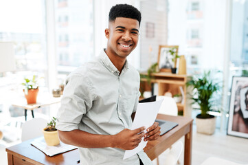 Poster - No task is too big for me to tackle. Portrait of a confident young businessman going over paperwork in a modern office.
