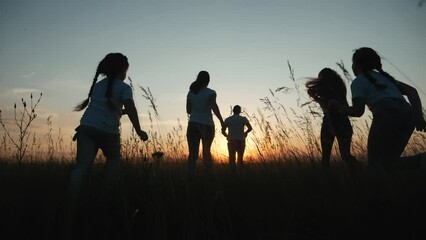 Wall Mural - happy family. people in park children a kid together run in park at sunset silhouette. mom dad daughter and son run. happy family and little baby child summer. fun kid dream concept. children run