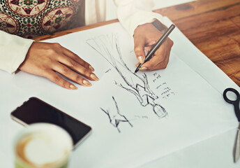 Canvas Print - Sketching is a crucial part of fashion design. Cropped shot of a fashion designer working on a new design.