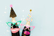 Carnival background. Party props and champagne on a light blue background. Holiday concept, purim