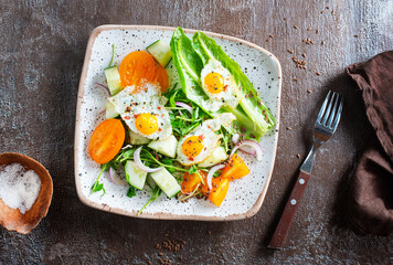 Wall Mural - fried eggs with vegetables, top view, diet salad with quail eggs