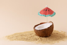  Creative Composition With Coconut And Sun Parasol. Tropical Beach Concept With Half Of Coconut.