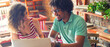 © Solid photos - Woman and man students studying in the coffee shop using laptop