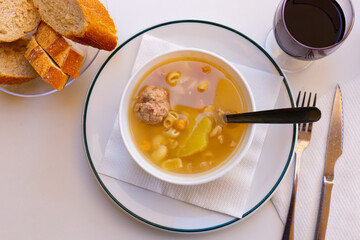 Organic soup with meatballs and noodles closeup