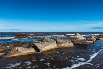 Wall Mural - Concrete blocks in Baltic sea, Kolka, Latvia.