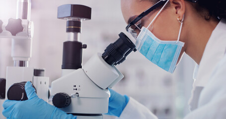 Wall Mural - theres always something new to discover under the lens. shot of a young scientist using a microscope