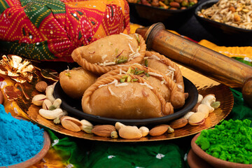 Indian Mithai Gujia Also Called Gujiya, Pirukiya, Pirukia, Pedakiya, Karanji, Basundi Gughra Made Of Suji Ghee Stuffed With Mawa Khoya Chasni Mava And Khoa With Holi Pagadi, Safa Pichkari Gulal Abeer