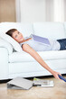 © Yuri A/peopleimages.com - Taking a much needed study break. Smiling young student lying on the sofa with all her books.