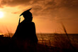 © jaboo_foto - Silhouette of university graduated woman in sunset sky