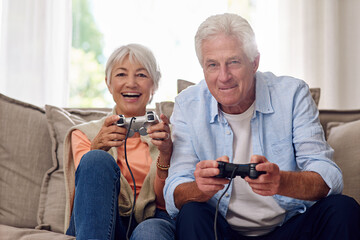 Poster - They have so much fun playing video games. Shot of a senior couple playing video games.