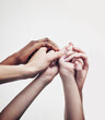 © Arnéll K/peopleimages.com - Coming together through diversity. Shot of a group of hands holding on to each other against a white background.