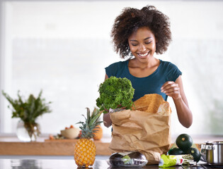 Poster - I hope the chef gets a kiss afterwards. Cropped shot of a young woman with some groceries.