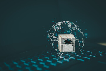 Leinwandbilder - Graduation cap icon with computer laptop icon on wooden cube block  which is placed on a laptop. Concept of online learning for students