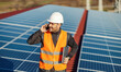 © dusanpetkovic1 - A worker talking on the phone with boss after testing solar panels on the roof.