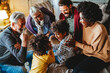 © NDABCREATIVITY - Portrait of happy multi-generation multiethnic family having fun together at home