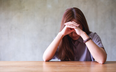 Wall Mural - A young asian woman feeling sad and stressed, sick and headache at home