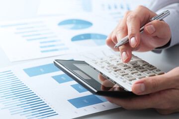 Aufkleber - Financial analysis concept. Working with calculator. Close up of hands. Many reports on desk.