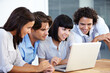 © Jason P H/peopleimages.com - Brainstorming - Business Teams. A group of young entrepreneurs having a business meeting over a laptop.