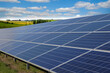 Leinwandbild Motiv Rows of solar panels and green nature