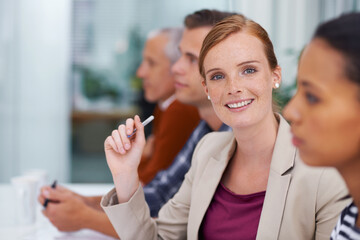 Poster - Taking this team to the top. Shot of a businesswoman smiling at the camera during a meeting with her colleagues.