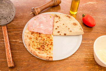 Wall Mural - Crispy pizza with bologna mortadella, without cheese, with oil, oregano and pepper on a wooden table