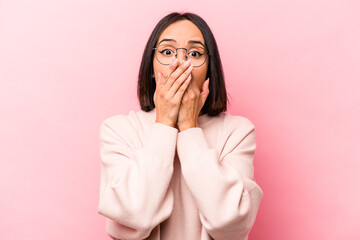 Wall Mural - Young hispanic woman isolated on pink background shocked covering mouth with hands.