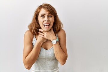 Sticker - Beautiful caucasian woman standing over isolated background shouting suffocate because painful strangle. health problem. asphyxiate and suicide concept.