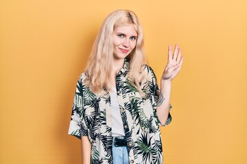 Sticker - Beautiful caucasian woman with blond hair wearing tropical shirt showing and pointing up with fingers number four while smiling confident and happy.